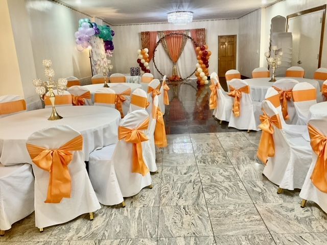 A room filled with tables and chairs decorated for a party.