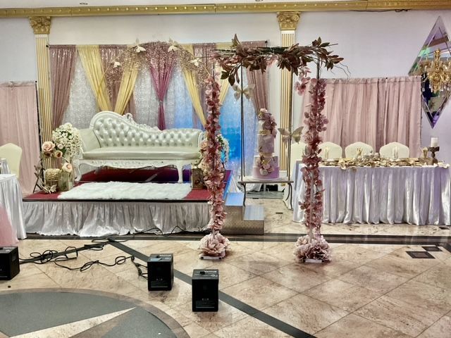 A room decorated for a wedding with a couch and a table.