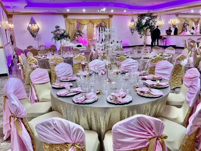 A large room with tables and chairs set up for a wedding reception.