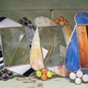 A group of stained glass mirrors are sitting on a table.