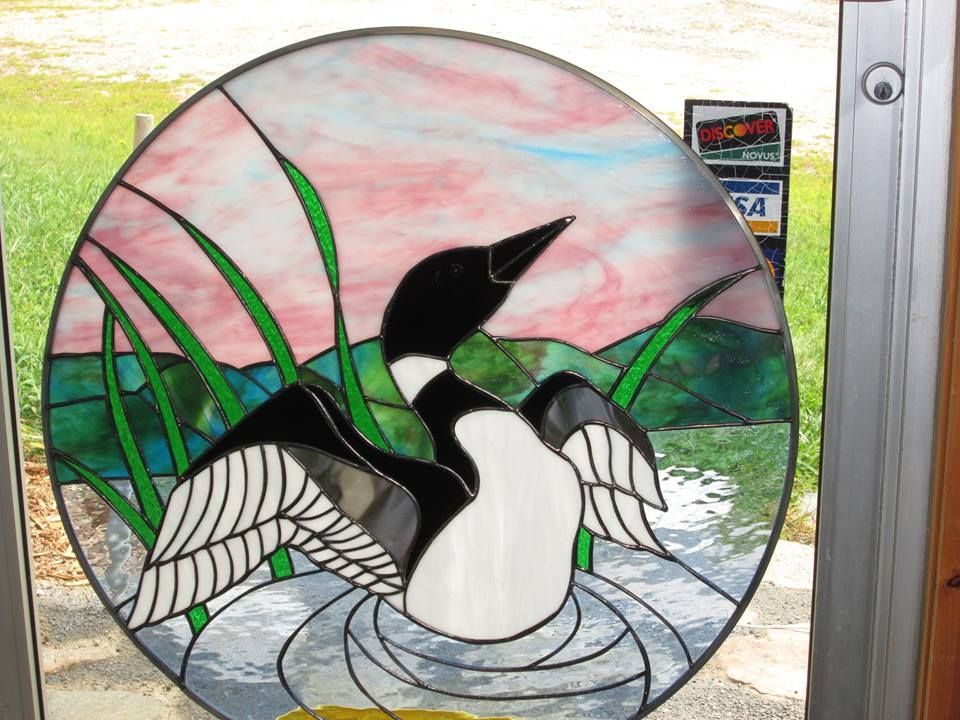 A stained glass painting of a goose in the water