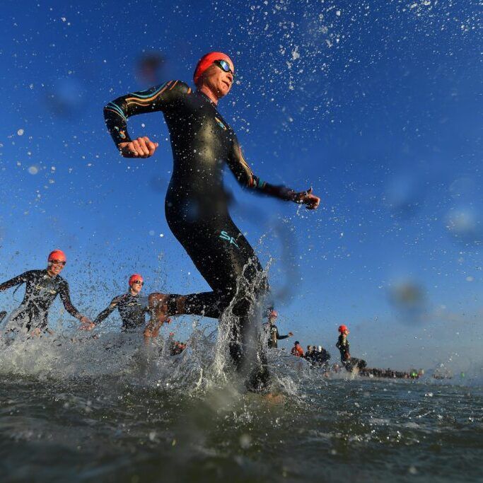 PORT ELIZABETH - SEPTEMBER 1: General view of Age Group Athletes entering the water for the swim start during the Isuzu IRONMAN 70.3 World Championship Women in Port Elizabeth, South Africa on September 1, 2018. Over 4,500 athletes from over 100 countries will be represented in this years 70.3 World Championship. (Photo by Donald Miralle/Getty Images for IRONMAN).