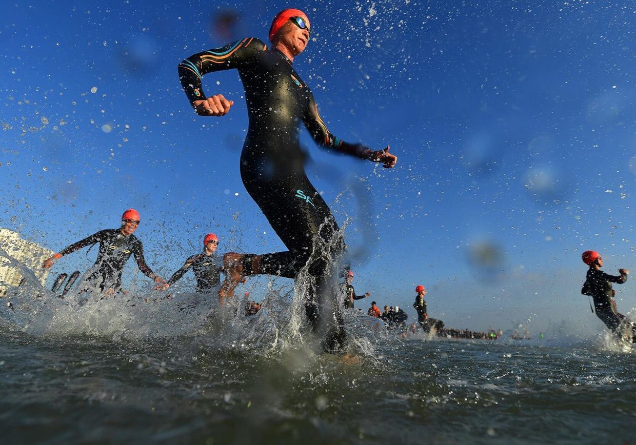 PORT ELIZABETH - SEPTEMBER 1: General view of Age Group Athletes entering the water for the swim start during the Isuzu IRONMAN 70.3 World Championship Women in Port Elizabeth, South Africa on September 1, 2018. Over 4,500 athletes from over 100 countries will be represented in this years 70.3 World Championship. (Photo by Donald Miralle/Getty Images for IRONMAN).