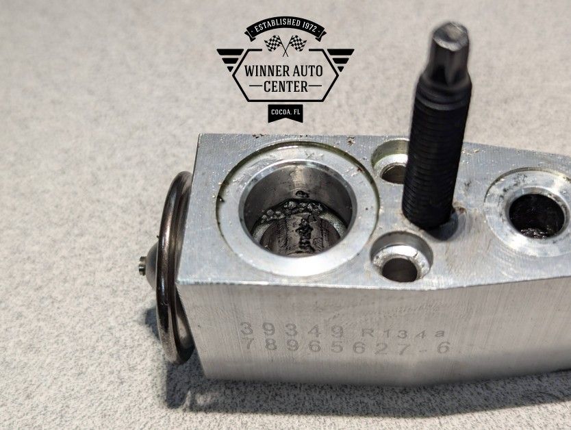 Close-up of a metal automotive part with an open circular cavity | Winner Auto Center