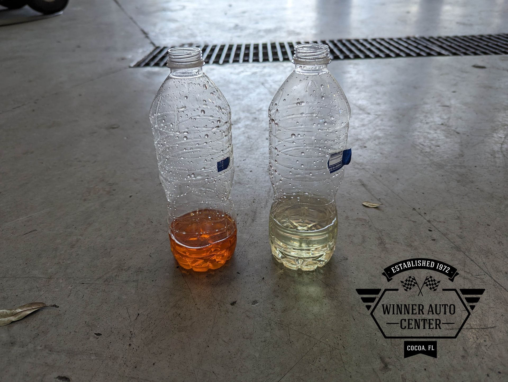 Two plastic bottles on a concrete surface | Winner Auto Center