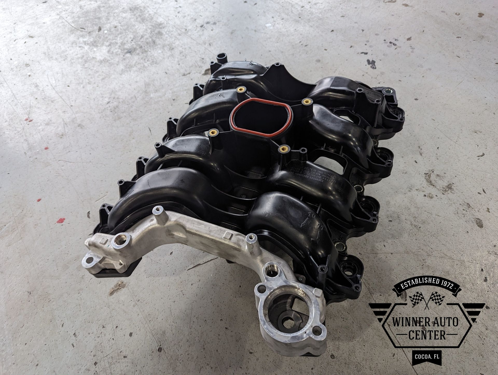 Black intake manifold with silver bracket | Winner Auto Center