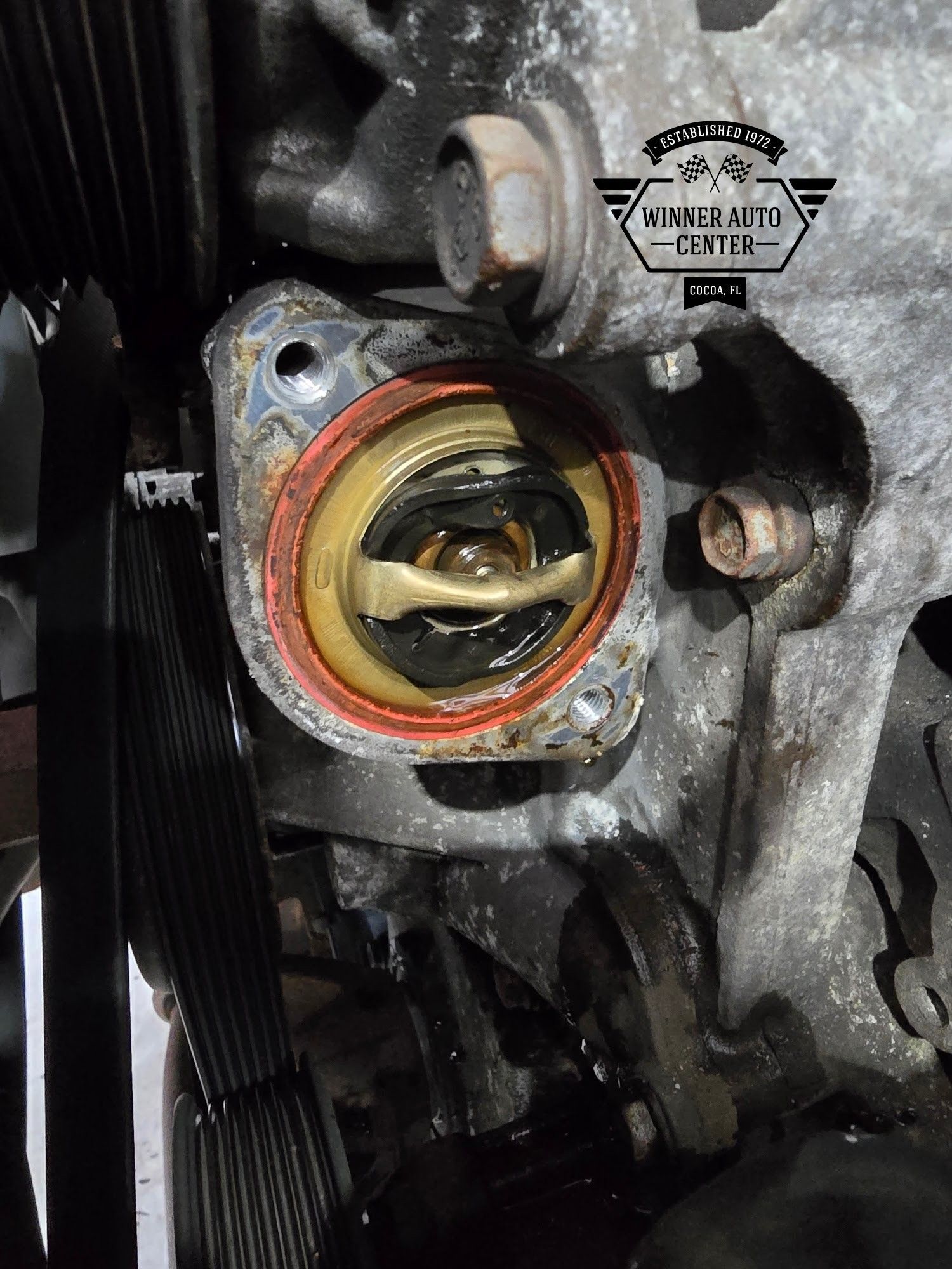 Close-up view of a car engine's thermostat housing | Winner Auto Center