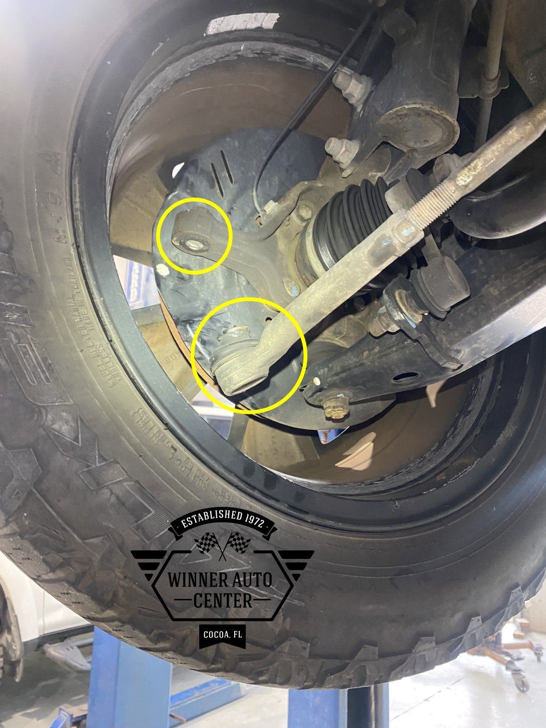 Front wheel assembly of a vehicle from below | Winner Auto Center