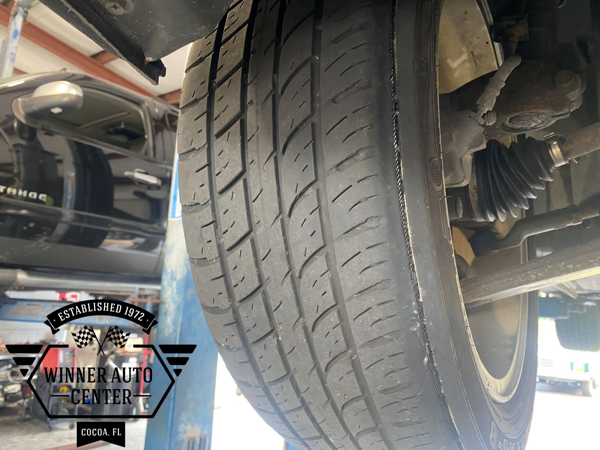 Close-up view of a car tire being inspected | Winner Auto Center
