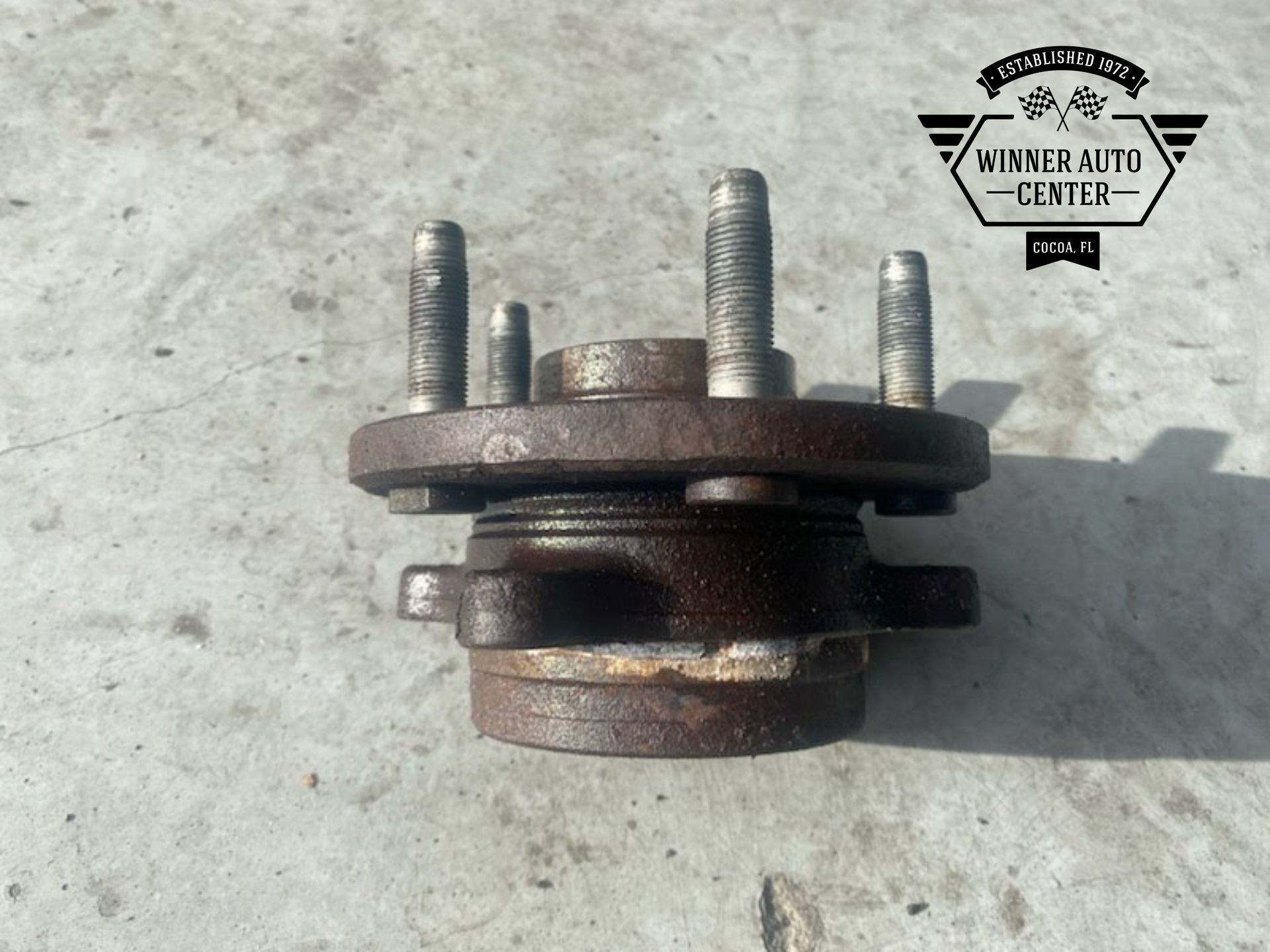 A rusty car wheel hub with mounting bolts | Winner Auto Center
