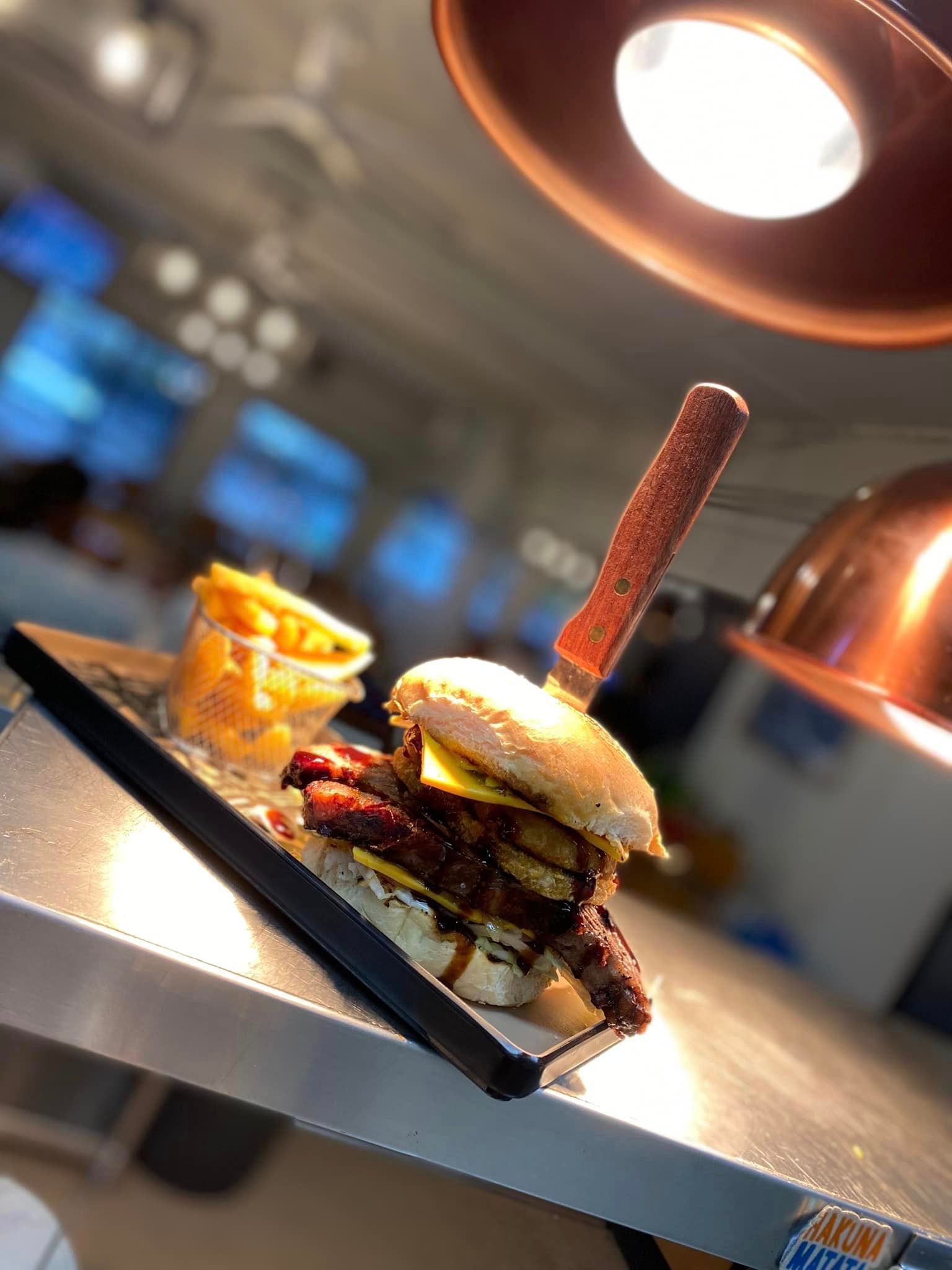 Fresh Tasty Burger And French Fries On Metal Table — Hart & Soul Bar and Grill in Toukley, NSW