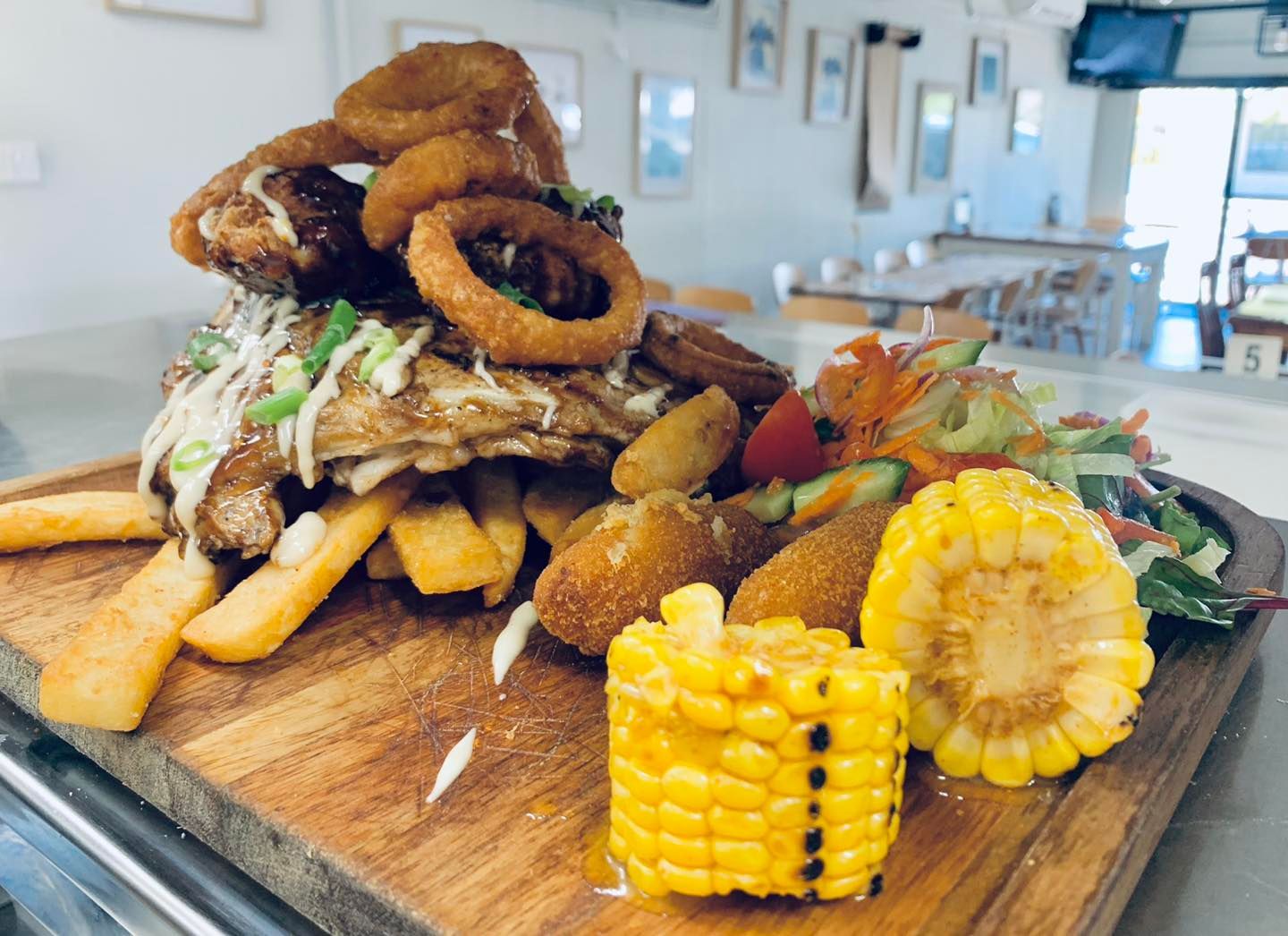 Slow cooked ribs with steakhouse chips and corn cobs — Hart & Soul Bar and Grill in Toukley, NSW