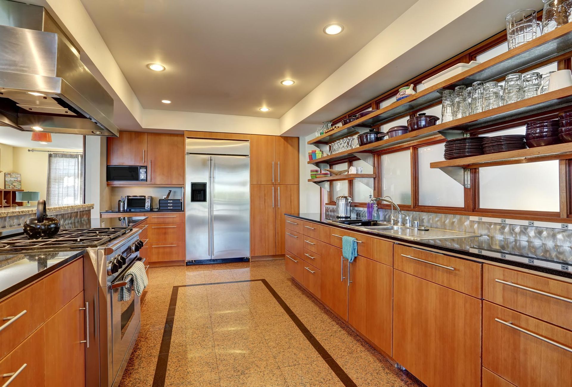 A kitchen with stainless steel appliances and wooden cabinets