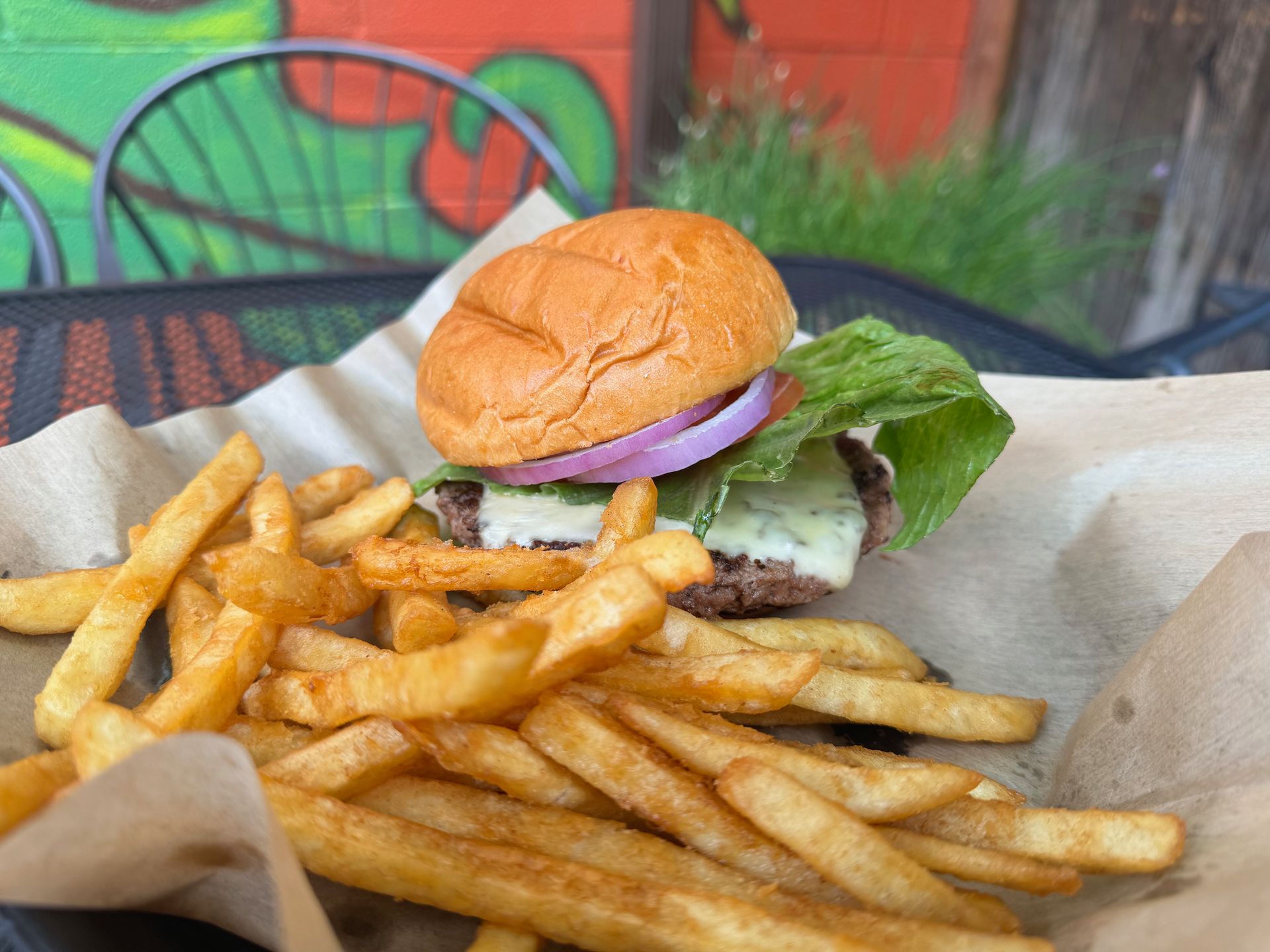 A hamburger and french fries are sitting on a table.