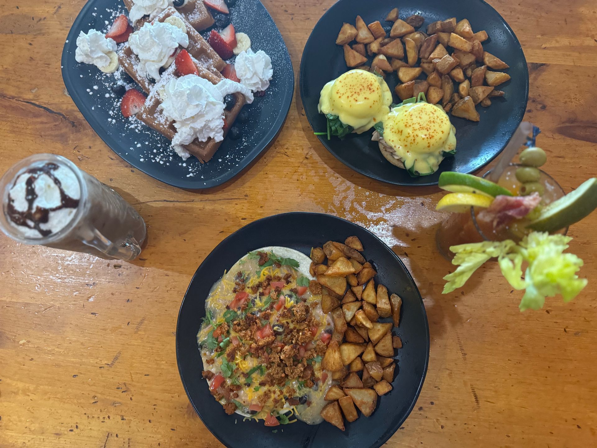 A table topped with plates of food and a drink.