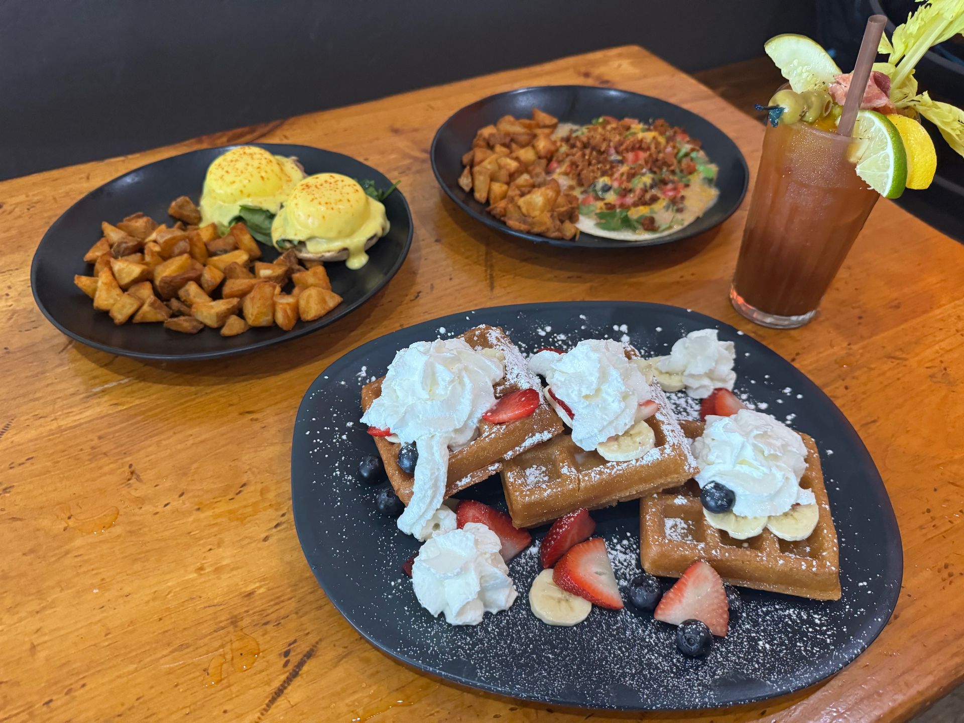A table topped with plates of food and a drink.