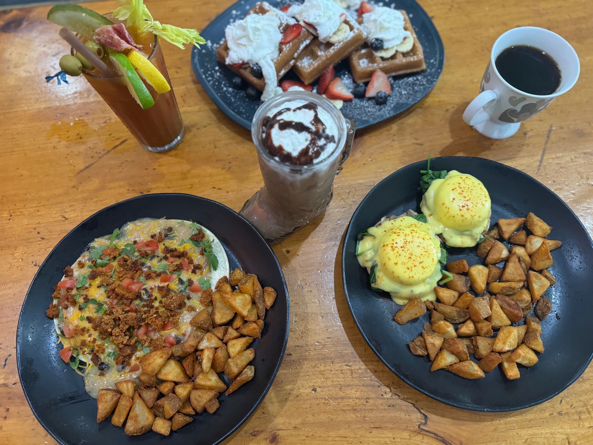 A table topped with plates of food and drinks.