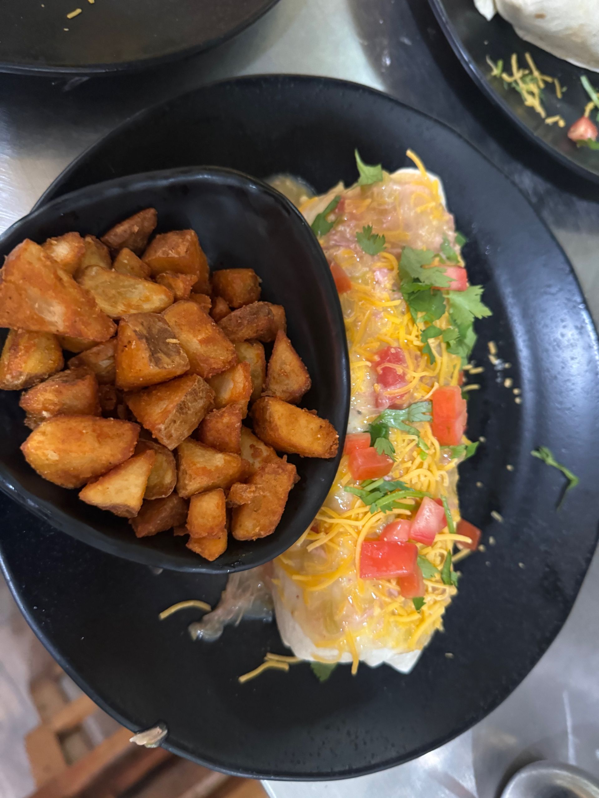 A plate of food with a bowl of potatoes on it
