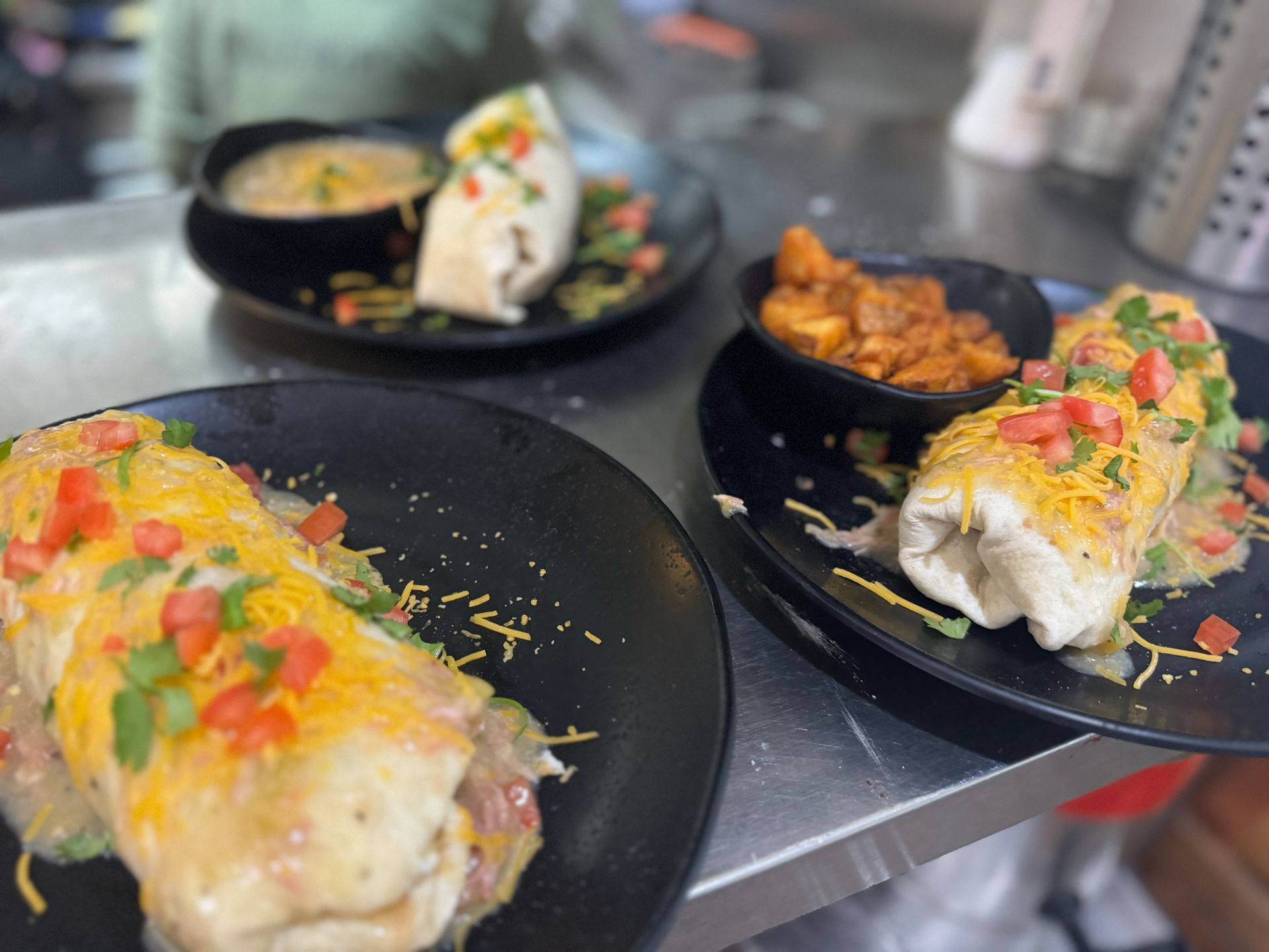 A close up of three plates of food on a table.