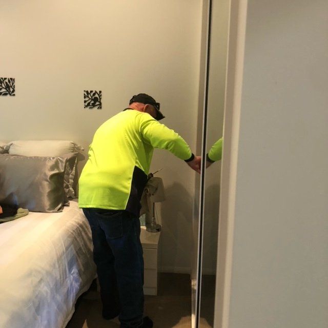 Pest Control Technician Spraying Pesticides in Bedroom — Residential & Commercial Pest Control in Sarina, QLD