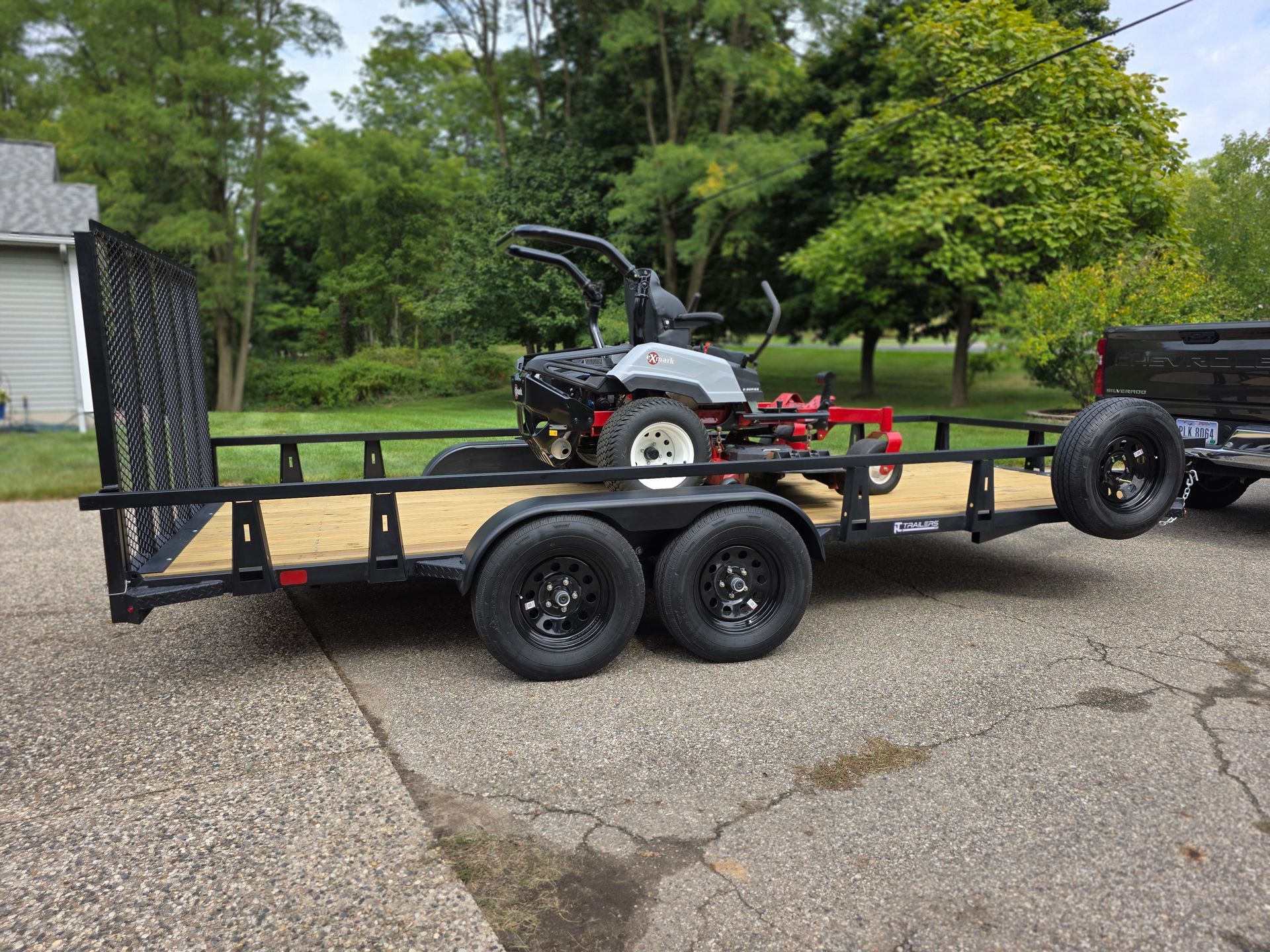 Mesh ramp in upright position on tandem steel utility trailer