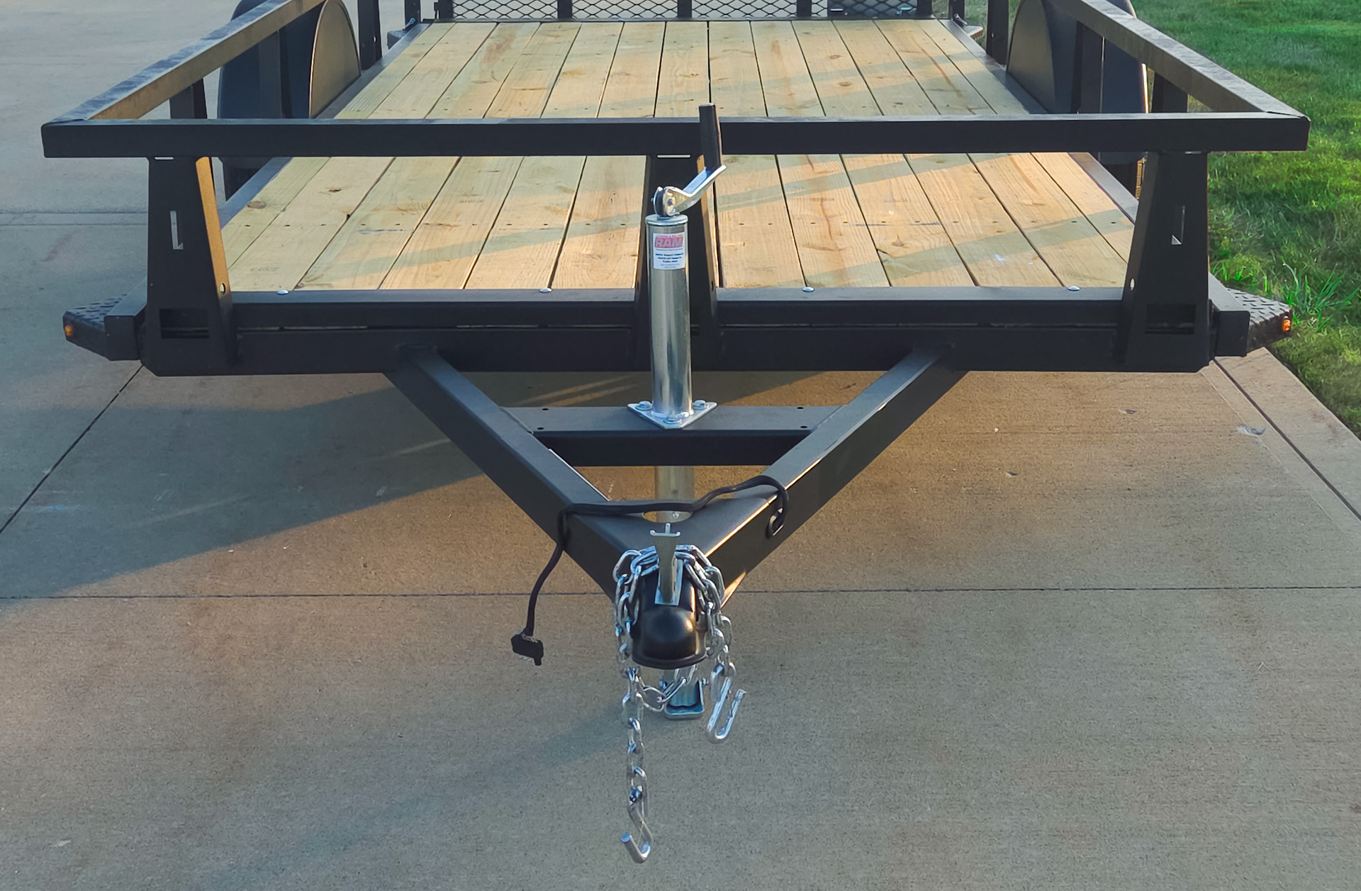 A frame tongue with tongue jack on steel utility trailer