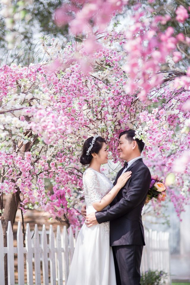 Bride and groom smiling together in a garden during their wedding