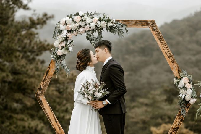 Bride and groom sharing a romantic kiss after their wedding ceremony.
