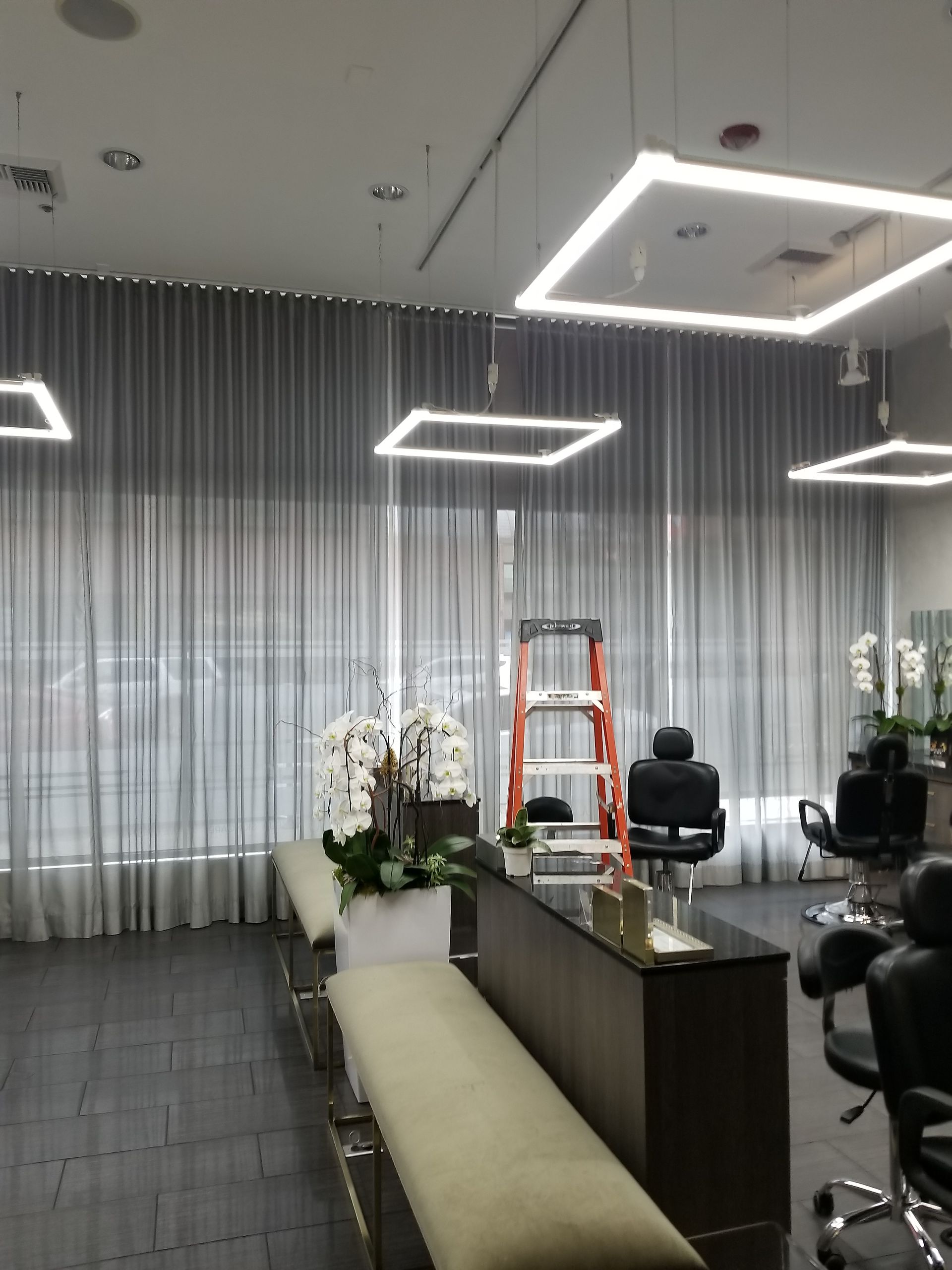 A salon with a ladder hanging from the ceiling