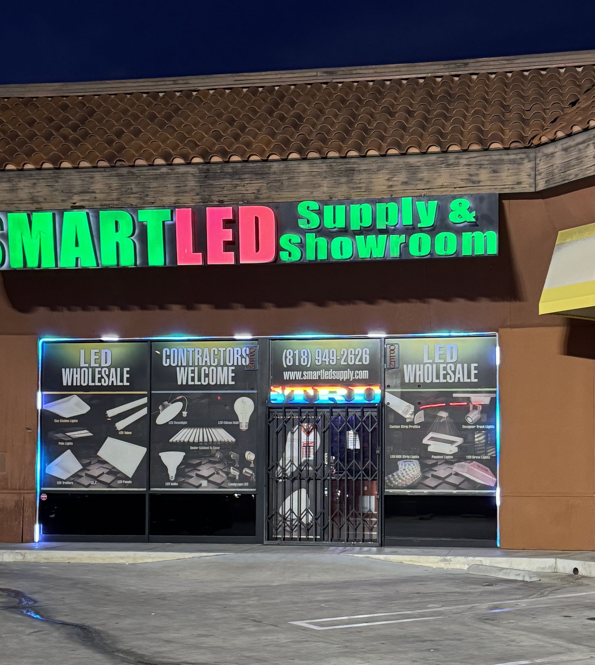 A smartled supply and showroom store front at night