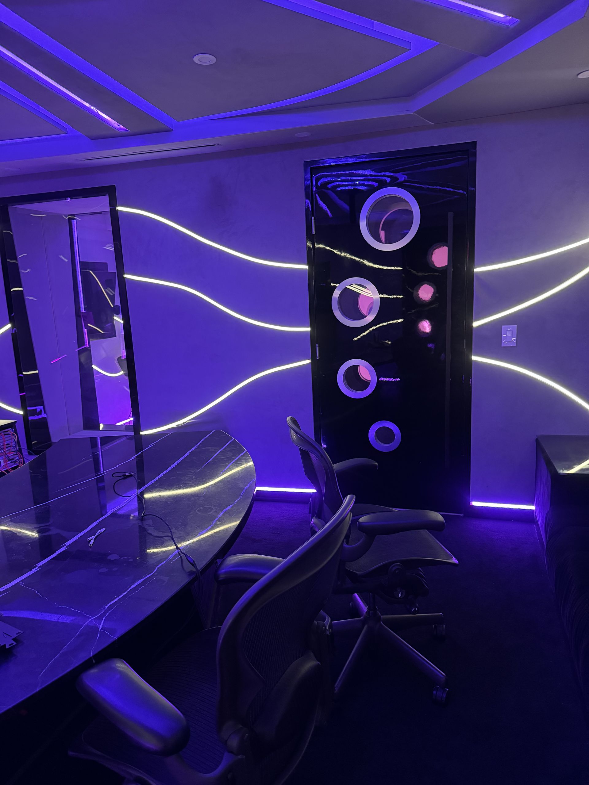 A person is holding a tablet in front of a recording studio.