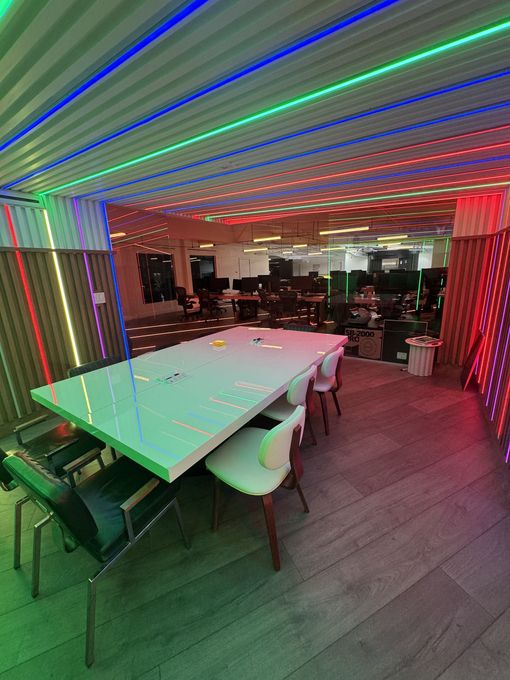There is a large table and chairs in the middle of the room.