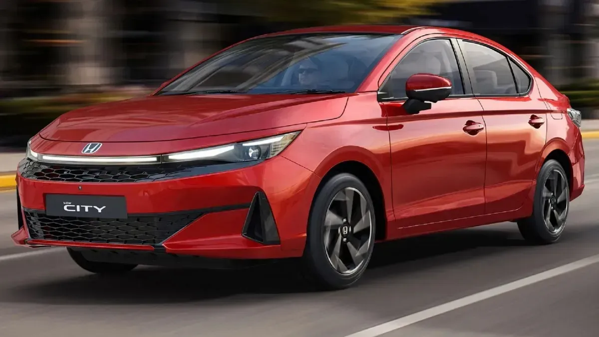 Red Honda sedan driving on a road, shown in motion against a blurred background.