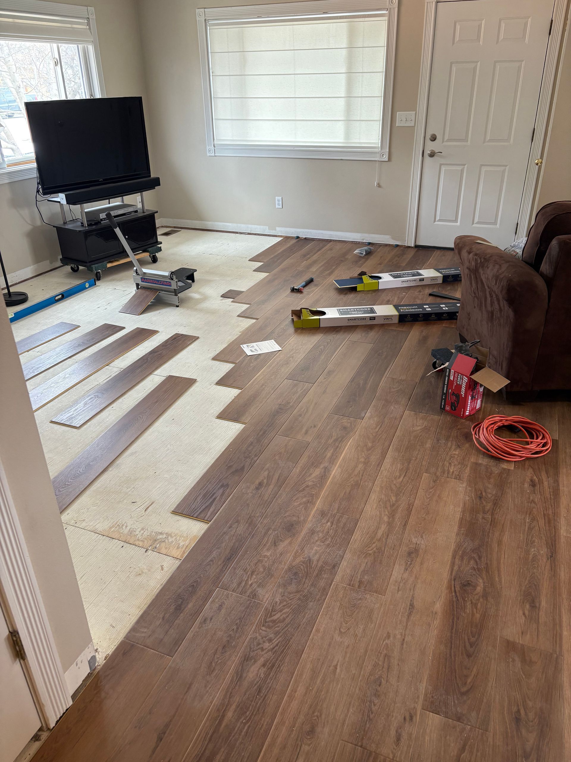 A living room with a wooden floor and a couch.