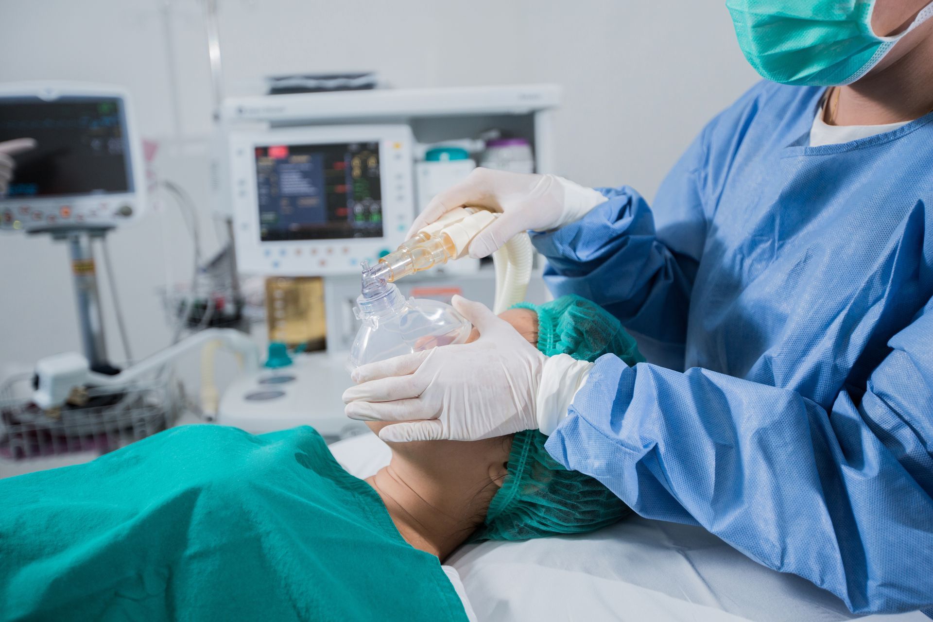 patient with anesthesia mask on face before procedure