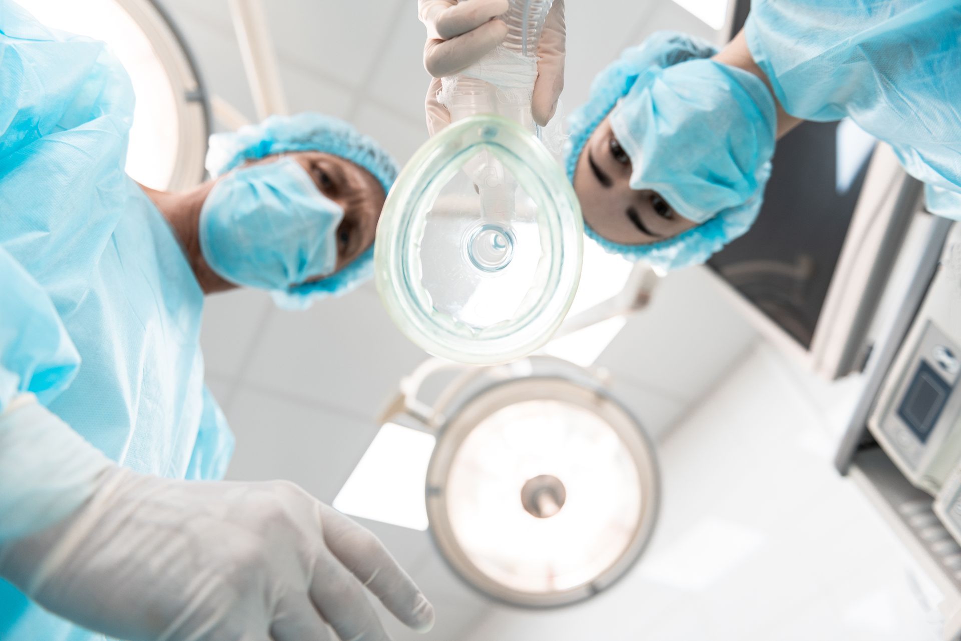 group of doctors applying anesthesia to patient in clinical surgical setting