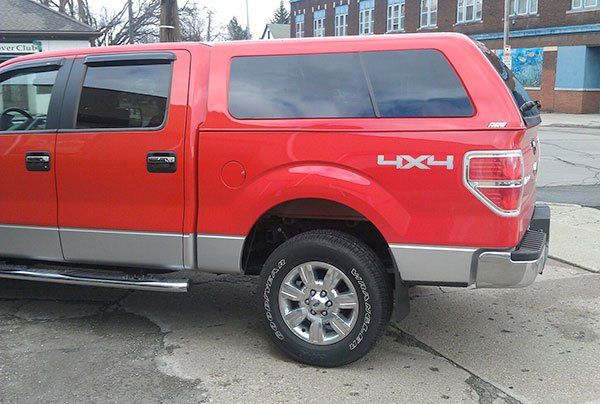 A red truck with the word 4x4 on the side