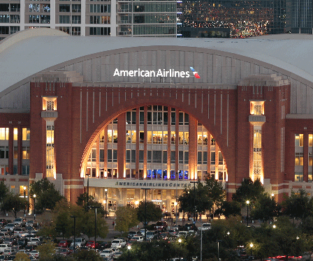 The american airlines building is lit up at night