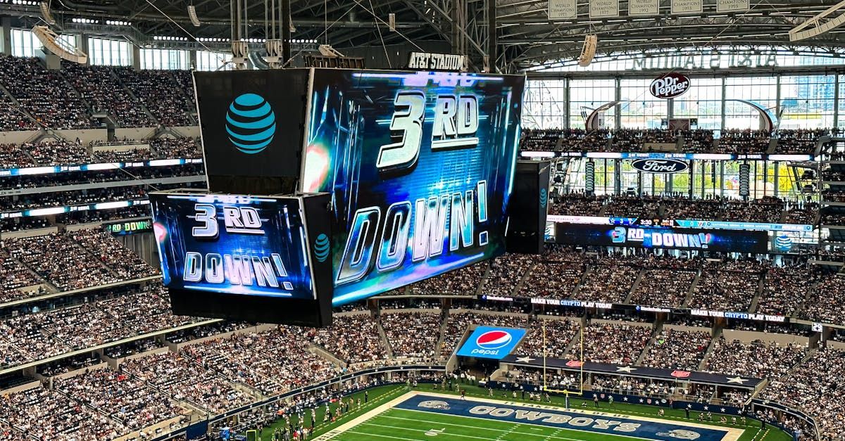 A stadium filled with people watching a football game.