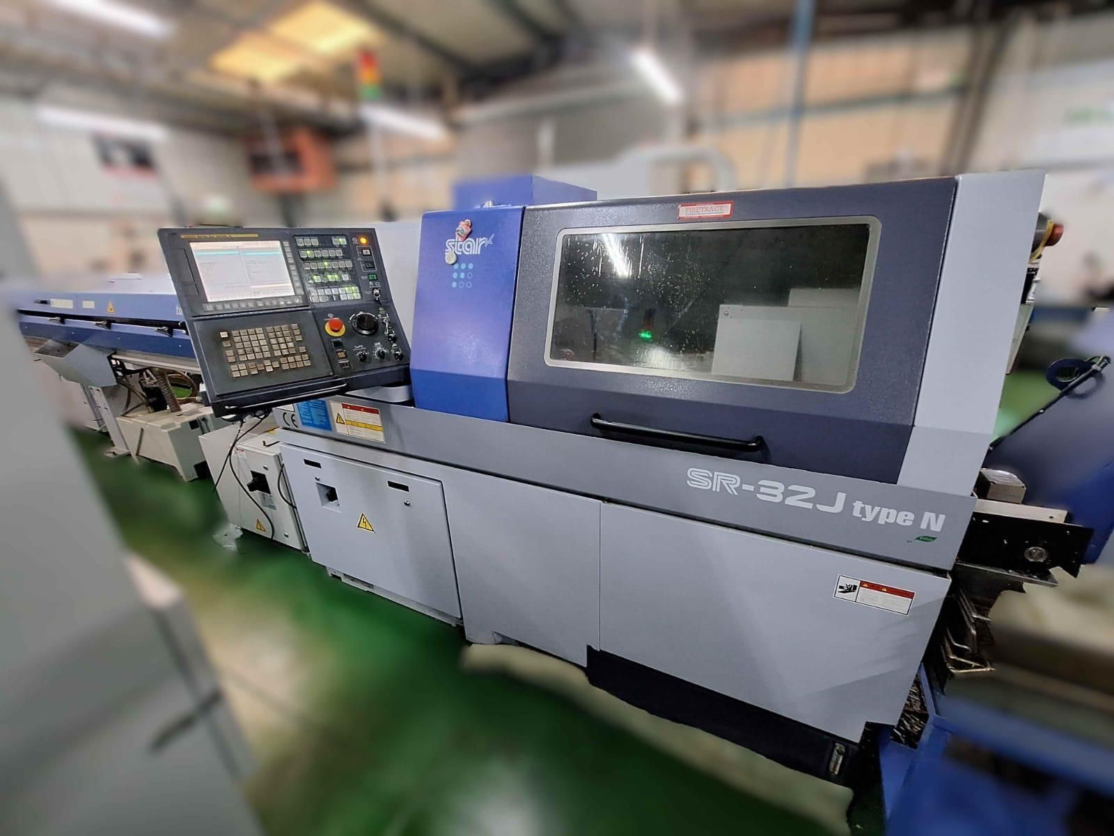 A large machine is sitting on the ground in a factory.