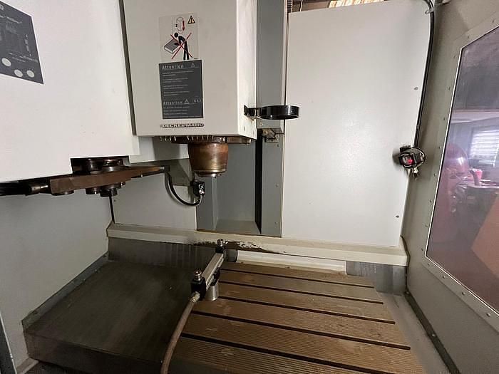 A machine is sitting on top of a wooden table in a room.