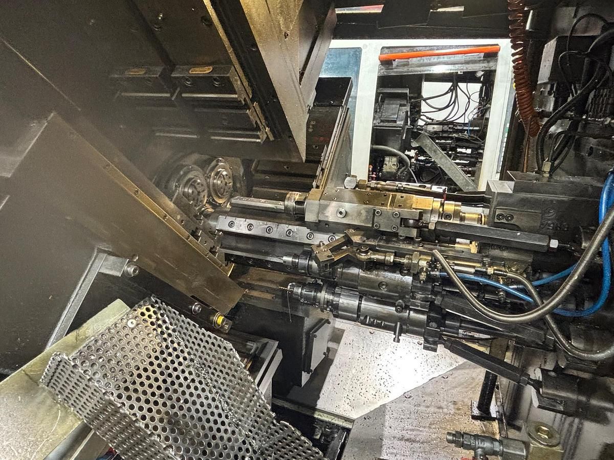 A machine is sitting in a dark room with a lot of wires coming out of it.