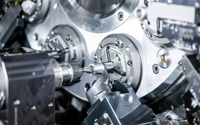 A machine is cutting a piece of metal in a factory.