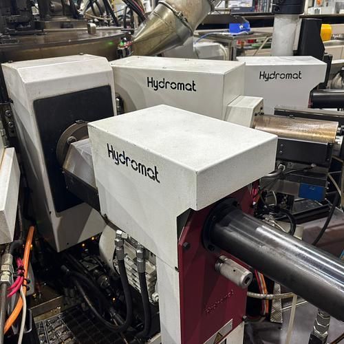 A machine with the word hydromat on it is in a factory.