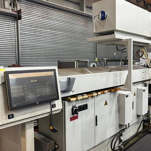 A machine is sitting in a room with a monitor on it.