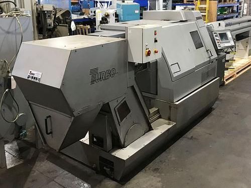 A large machine is sitting on the ground in a factory.