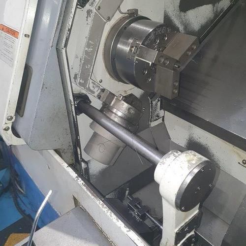 A machine is sitting on top of a table in a factory.