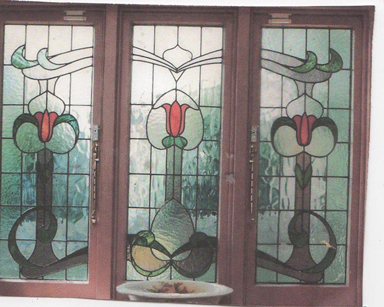 three panel leadlight window with red flowers and vines