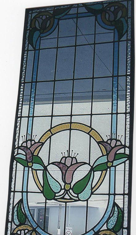 tall leadlight window with purple flowers with yellow and blue trim