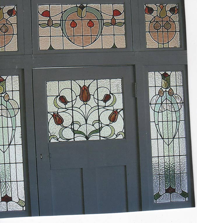 outdoor view of a door with leadlight windows of roses around it
